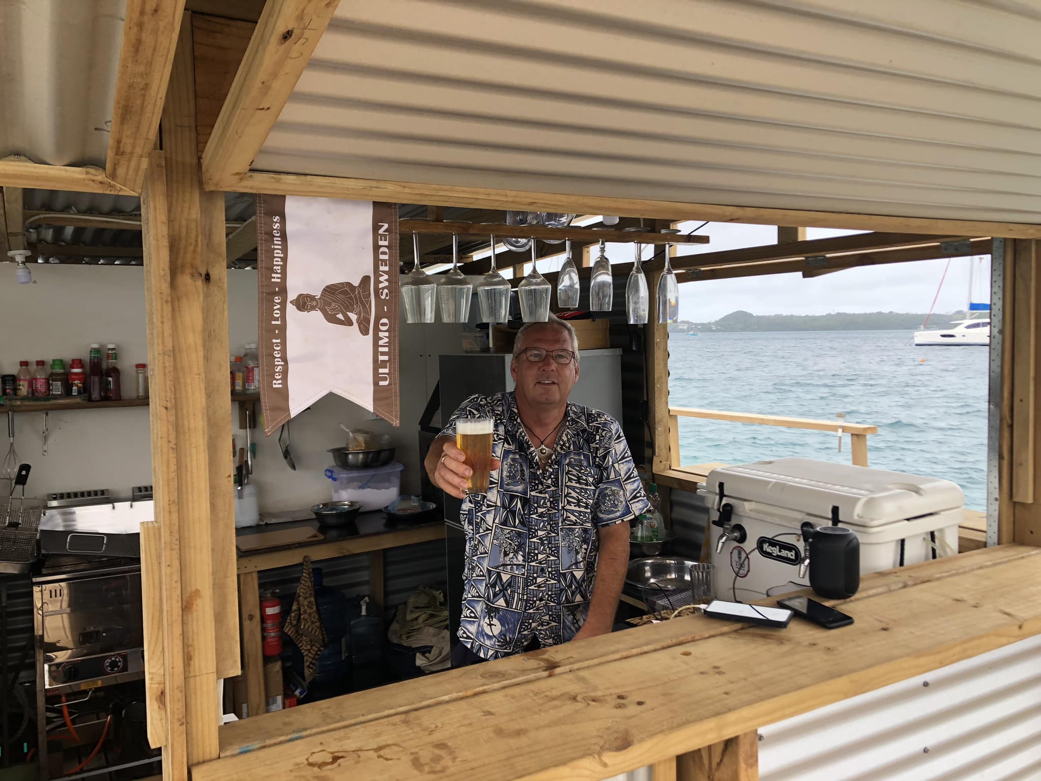 A happy owner serving customers on the floating bar in Vava'u